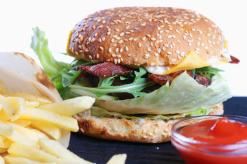 Cheeseburger with fries and ketchup.