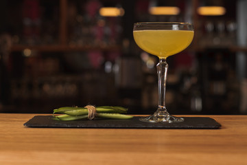 Glass of cocktail on bar background