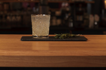 Glass of cocktail on bar background