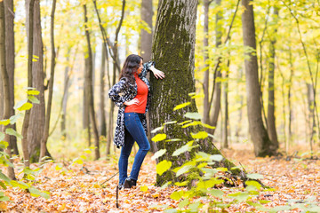 Autumn concept - Beautiful young modern woman on nature