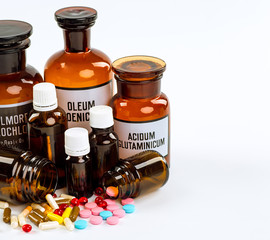 Various cold prescription bottles and a syringe isolated on a wh