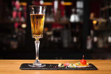 Glass of cocktail on bar background