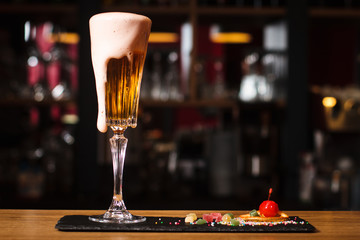 Glass of cocktail on bar background