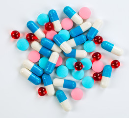 Various cold prescription bottles and a syringe isolated on a wh