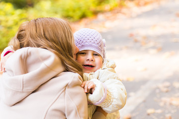 Mother and daughter in the autumn park