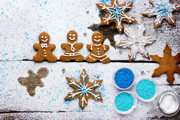 Gingerbread man and cookies snowflakes on a snowy background