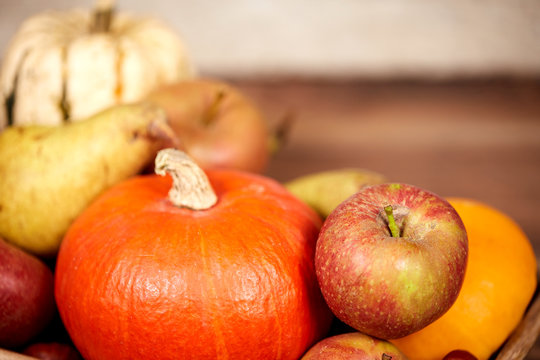Pumpkin and apple as autumn fruits on a table