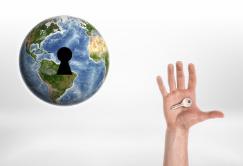 Human hand with the key from planet Earth.