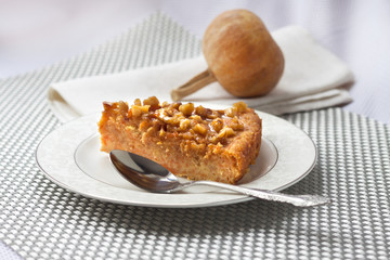 Piece of pumpkin pie with walnuts