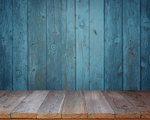 Blank wooden table on a background of the blue wall.