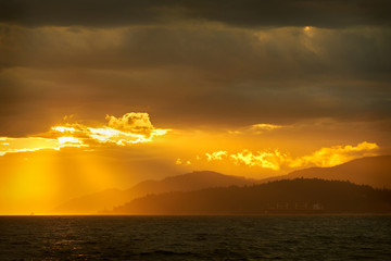 Break in the Storm, West Vancouver. The sun breaks through storm clouds over Georgia Strait. West...