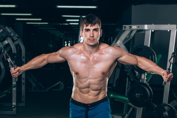 Fototapeta na wymiar handsome bodybuilder works out pushing up excercise in gym