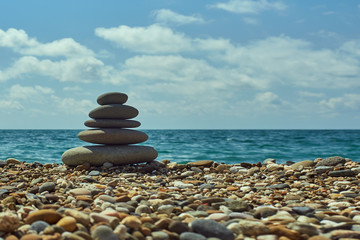 Fototapeta na wymiar Stack of round smooth stones on a seashore. Relax image.