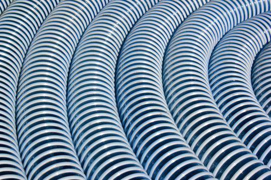 Blue and white corrugated plastic hose as background
