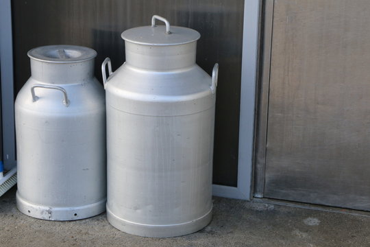 Two milk churns in front of the dairy, zwei Milchkannen vor der Molkerei