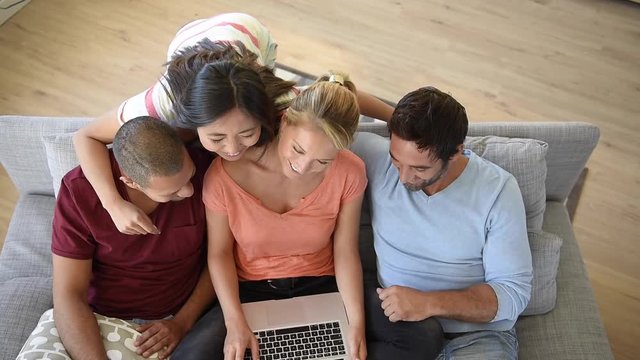 Group of friends sitting in couch websurfing on internet