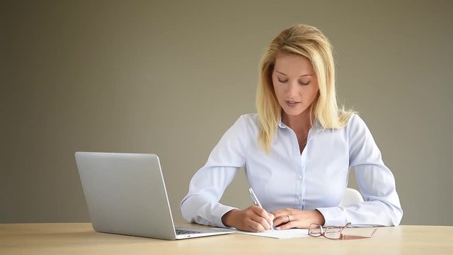 Portrait of businesswoman using laptop, isolated