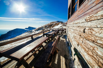 Wooden tables on patio at ski resort