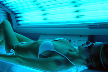 woman getting Solarium beauty treatment - obrazy, fototapety, plakaty