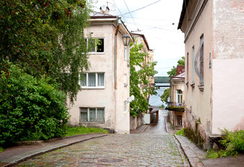 Fototapeta na wymiar Old pavement street after rain in Vyborg, Russia.
