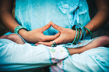 woman hands and legs in meditative pose