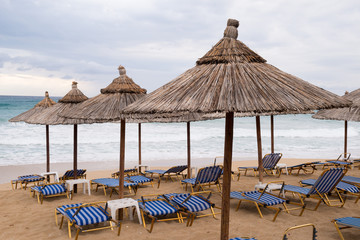 Thatch umbrellas on the beach in Greece