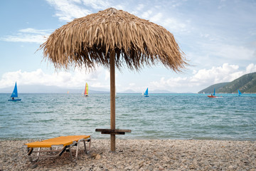 Fototapeta na wymiar Thatch umbrellas on the beach in Greece
