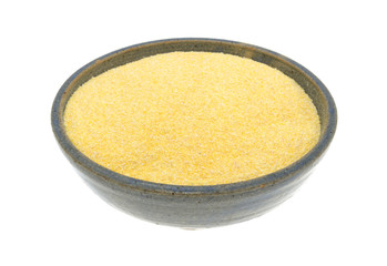 Corn meal in a bowl on a white background