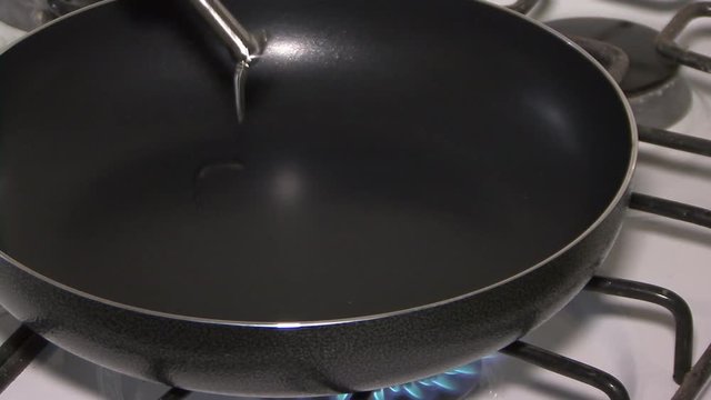 Cooking with pan in the stove with tomatoes
