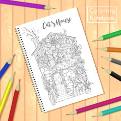 Spiral bound notepad or coloring book with pencils and picture, cats house.