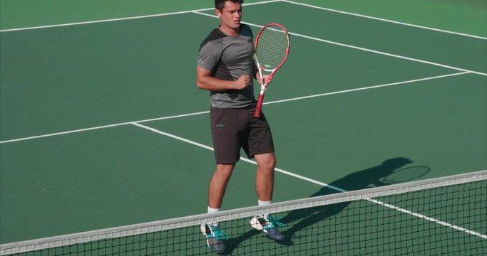 Tennis player returns and celebrates great shot