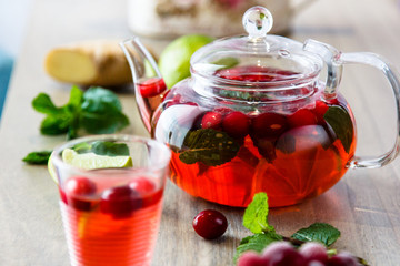 Tea in a glass teapot from the strawberries and raspberries