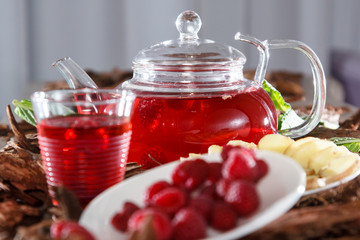 Tea in a glass teapot from the strawberries and raspberries
