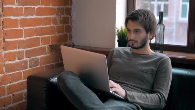 Young Entrepreneur Freelancer Working using a Laptop and in Coworking