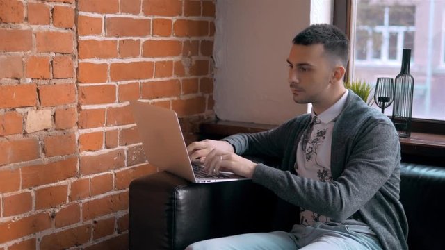 Young Entrepreneur Freelancer Working using a Laptop and in Coworking