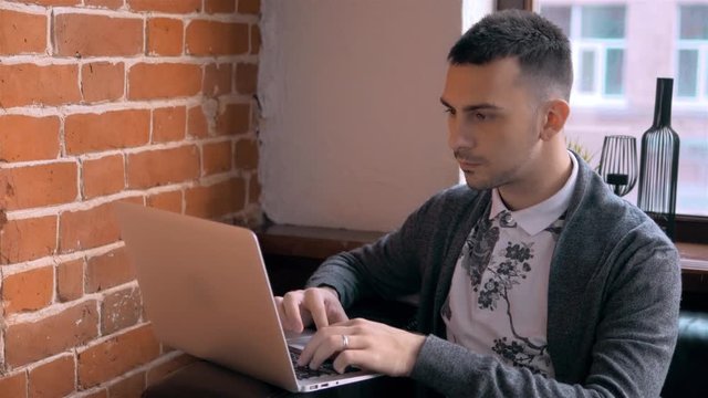Young Entrepreneur Freelancer Working using a Laptop and in Coworking