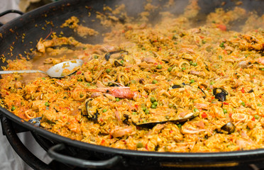 Seafood paella in a paella pan at a street food market