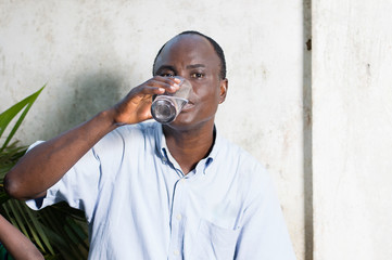 middle-aged man drinking water in a glass