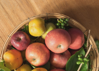 Naklejka na ściany i meble Fruits and vegetables in basket on wood table