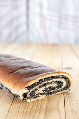 Strudel with poppy seeds on the wooden retro table