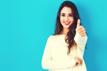 Happy young woman giving a thumb up