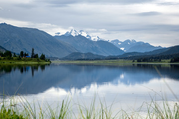 Reflection of hight mountain in crystal lake. Yazevoe lake. Alta
