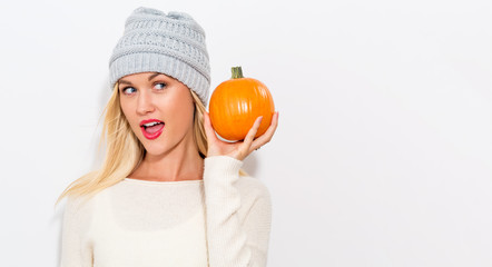 Young woman holding a pumpkin