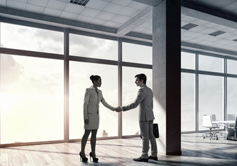 Fototapeta premium Business partners handshake . Mixed media
