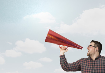 Fototapeta premium Hipster man shout in trumpet . Mixed media