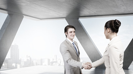 Fototapeta premium Business partners handshake . Mixed media