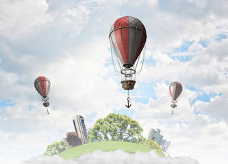 Aerostats flying over sky . Mixed media