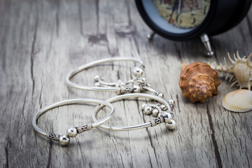 Silver bracelet on wooden background