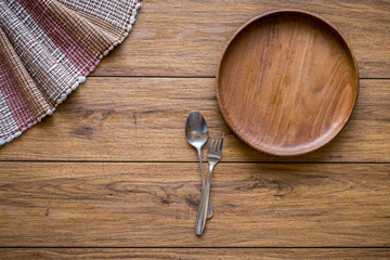 old wooden table with empty plate on a wooden table and copyspac