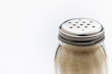 Parmesan Cheese shaker close up on white background.